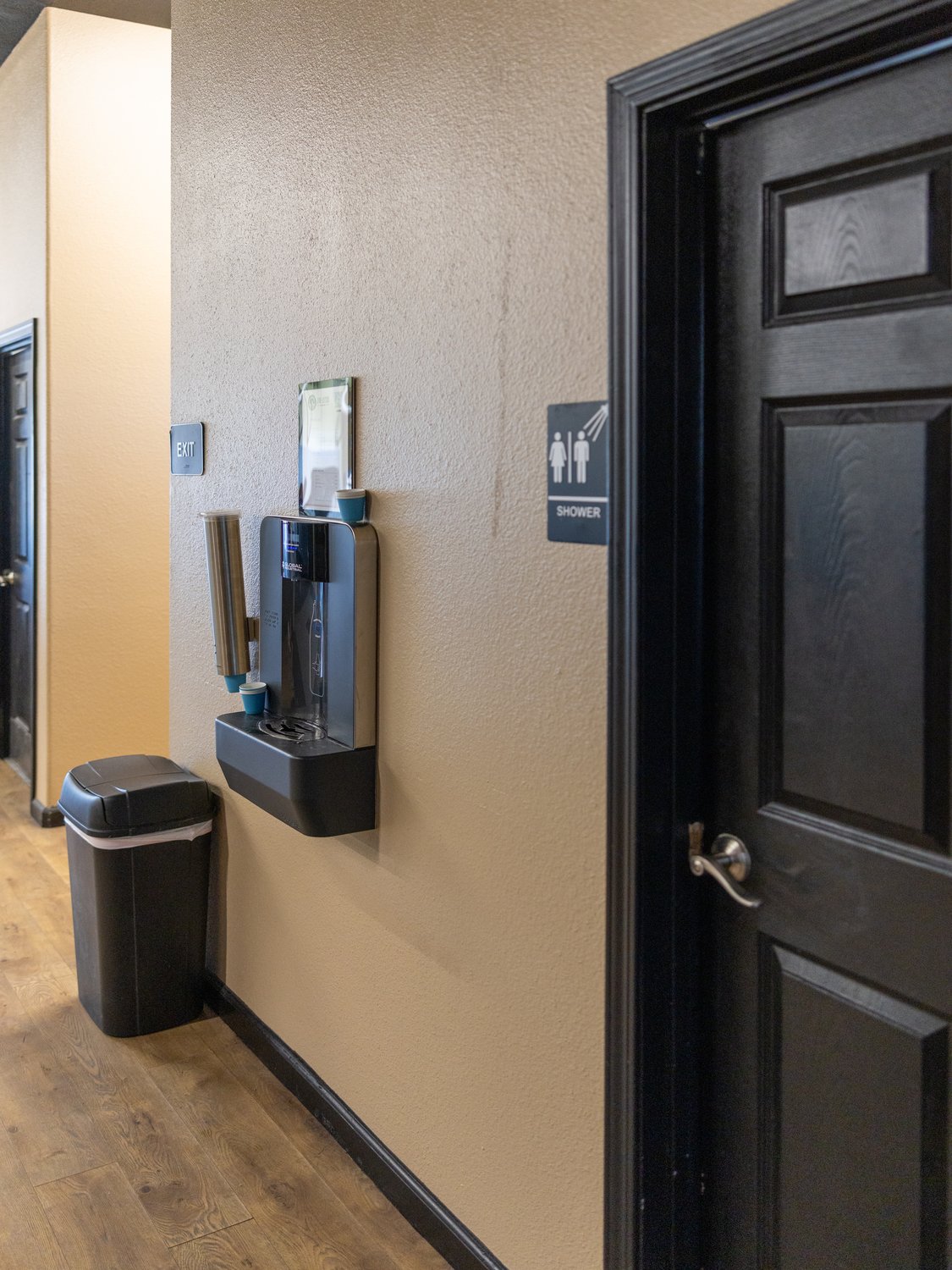 Shower room door and filtered water station in the academy hallway