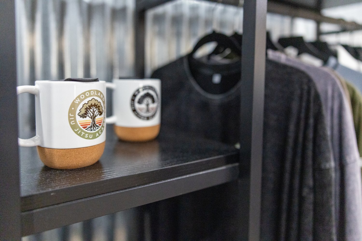 Academy mugs on a pro shop shelf